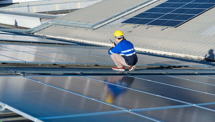 Man inspecting solar array