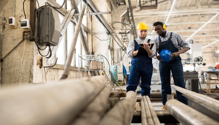 inspectors ensuring safety stacked pipes